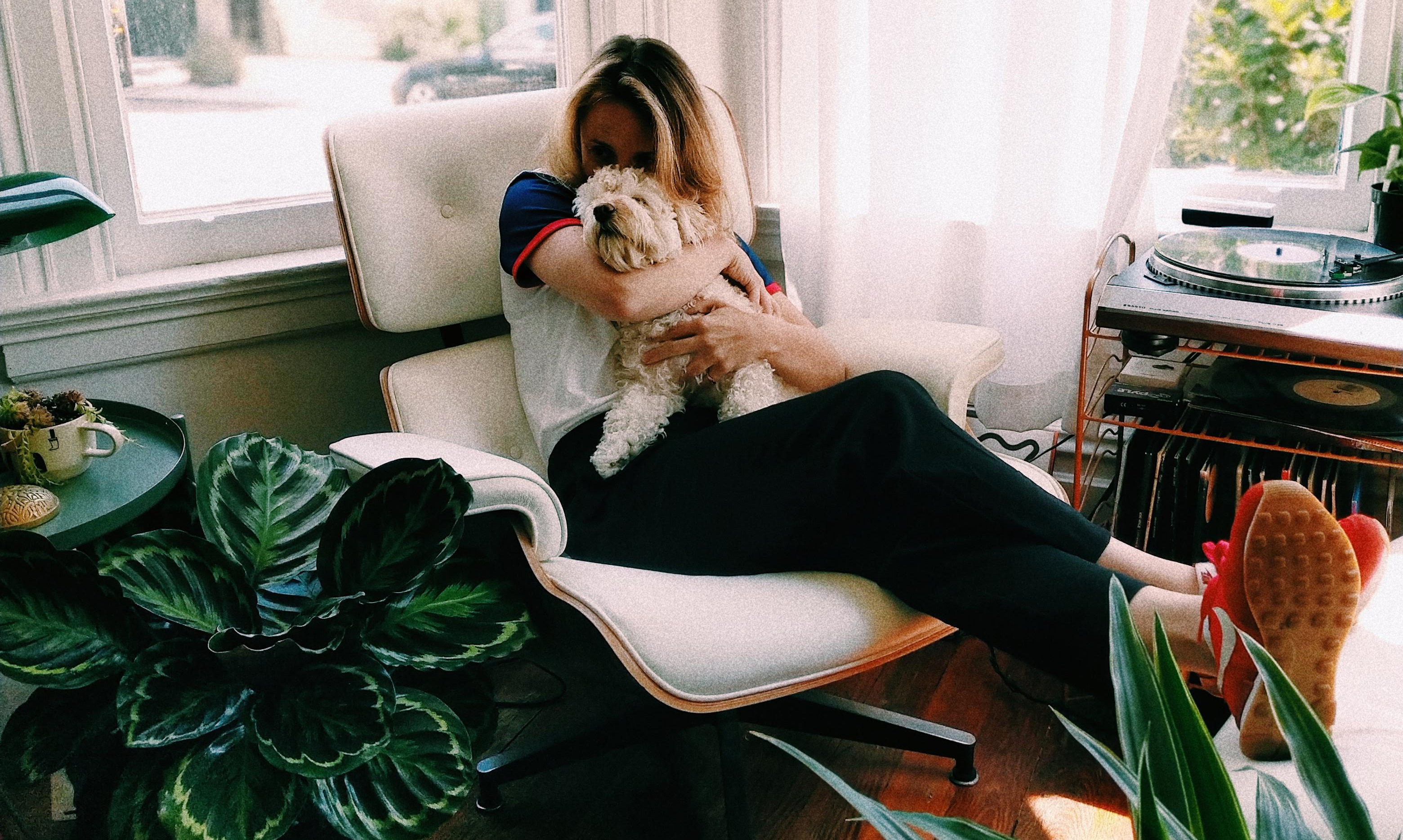 Woman cuddling dog 