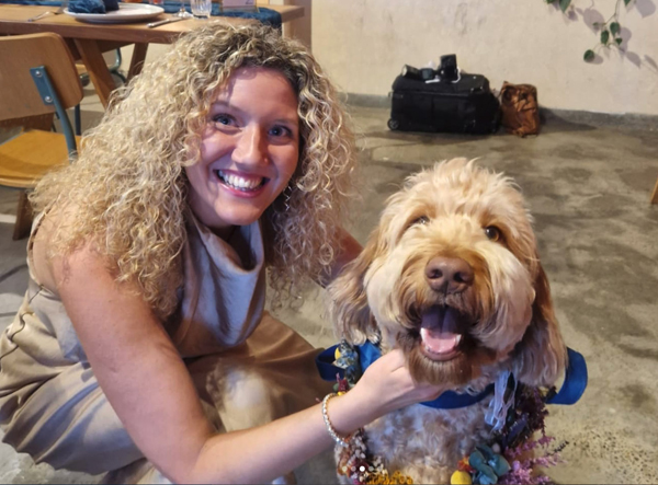 Pet and house Sitter Hayley caring for a happy dog in their home.